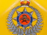a badge on the back of a yellow car