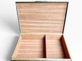 a small wooden box with a lid open on a white surface