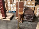 a floor lamp that is on a stand in front of boxes