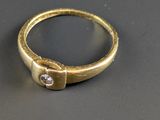 an image of a gold ring with a diamond in the middle