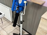 a blue blow dryer sitting on a stand in a room