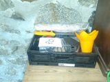 a black box with a yellow glove and a hard drive in it