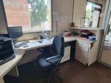 a desk with a computer and a printer in a room