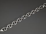 a close up of a silver bracelet on a black surface