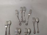 a lot of forks and spoons that are on the table