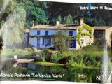 a magazine with a picture of a house and a pond