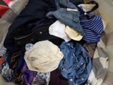 a basket full of clothes that is sitting on the floor