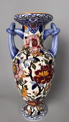 a vase with a floral design on it on a table