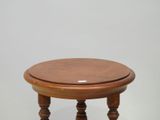 a small wooden table with a wooden top on a white surface