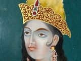 painting of a woman in a yellow dress and a gold hat