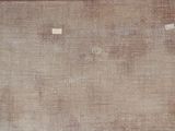 a brown area rug with white squares on it