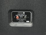 a close up of a black speaker with a red button