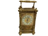 a gold clock that is sitting on top of a table