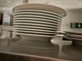 many plates stacked on top of each other in the kitchen