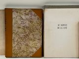 several old books are lined up on a shelf next to each other
