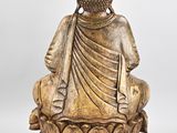 a statue of a buddha sitting on top of a lotus flower
