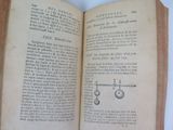 an open book with a drawing of a pair of scissors on it