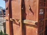 a dumpster that is sitting in the dirt