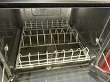 an empty dishwasher in the middle of an oven