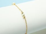 a close up of a gold bracelet on a white napkin