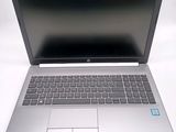 a laptop computer that is sitting on a white surface