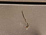 a close up of a piece of metal with a hole in it