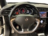 the interior of a car with a steering wheel and dashboard controls