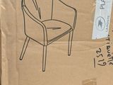 cardboard box with a drawing of a chair on it sitting on a pallet