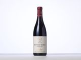 a bottle of red wine sitting on top of a table