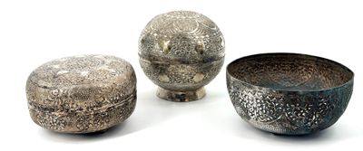 three silver bowls sitting next to each other on a white surface