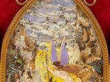 a picture of a painting in a gold frame on a red wall
