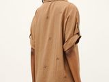 an image of a woman in a brown shirt dress