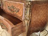 a wooden table with a marble top and drawers