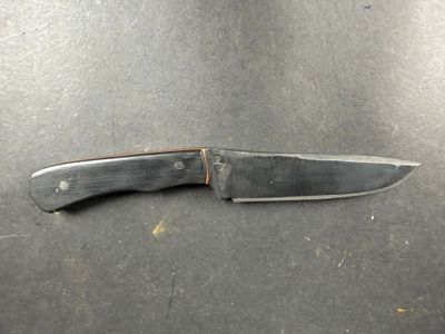 a knife that is laying on top of a table