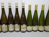 six bottles of wine are lined up on a table