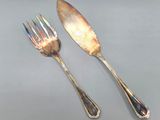 two spoons and a fork on a table