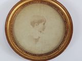 portrait of a young boy in a gold frame with a white background