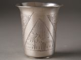 a silver cup that has a design on it