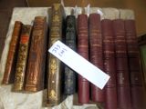many old books on a table with a tag on it
