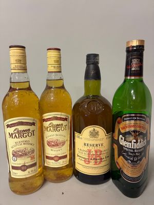 four bottles of alcohol are lined up in a row on a table
