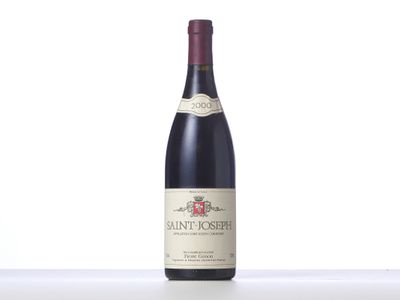 a bottle of red wine sitting on top of a table