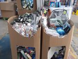two cardboard boxes filled with assorted items in a warehouse