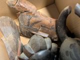 a cardboard box filled with assorted pieces of art