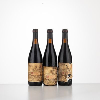 three bottles of wine sitting on top of a table next to each other