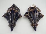 two blue and gold wall sconces on a white background