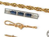 a lot of gold and silver jewelry on a white surface