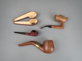 a lot of different types of smoking pipes on the table