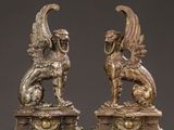 pair of antique bronze sculptures of a winged horse and a lion