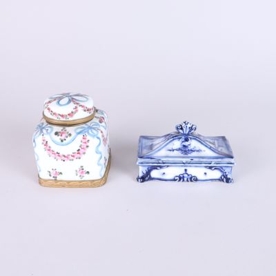 pair of blue and white porcelain boxes with lids on a white surface