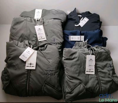 four pairs of men ' s clothing are on display in a store